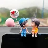 couple figurine car dashboard